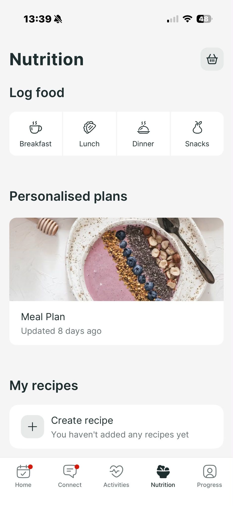 A mobile app nutrition screen showing options to log meals, a featured smoothie bowl meal plan, and a recipe creator.