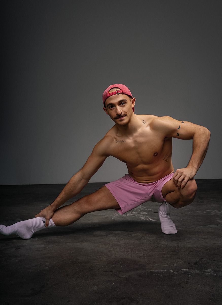 Coach is posing while stretching his body.
