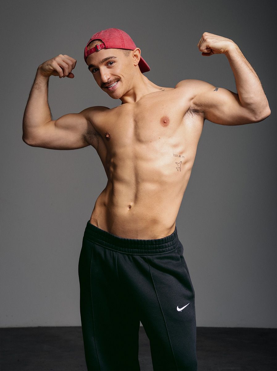 Coach is flexing both arms.