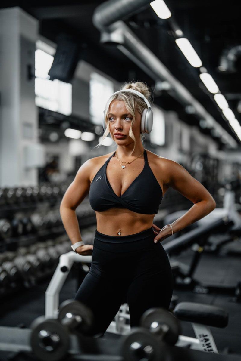 The coach is posing at the gym.