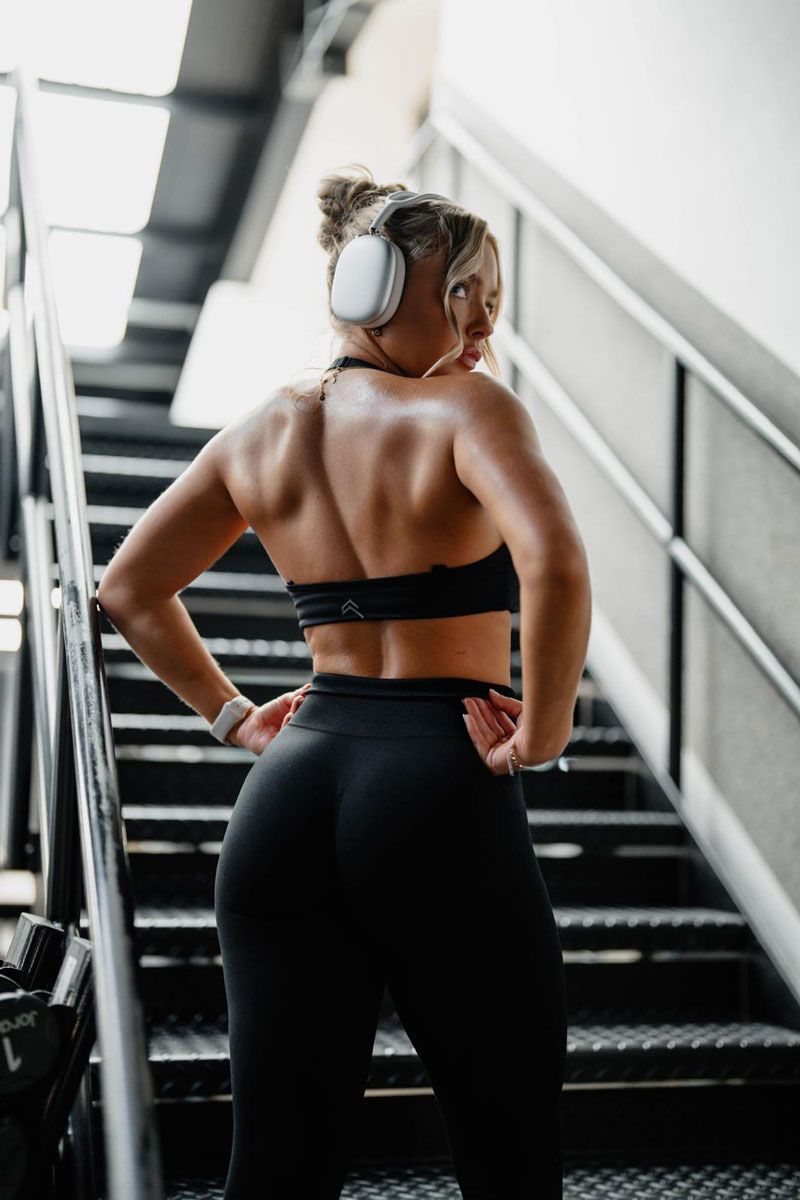 The coach is showing her back muscle.