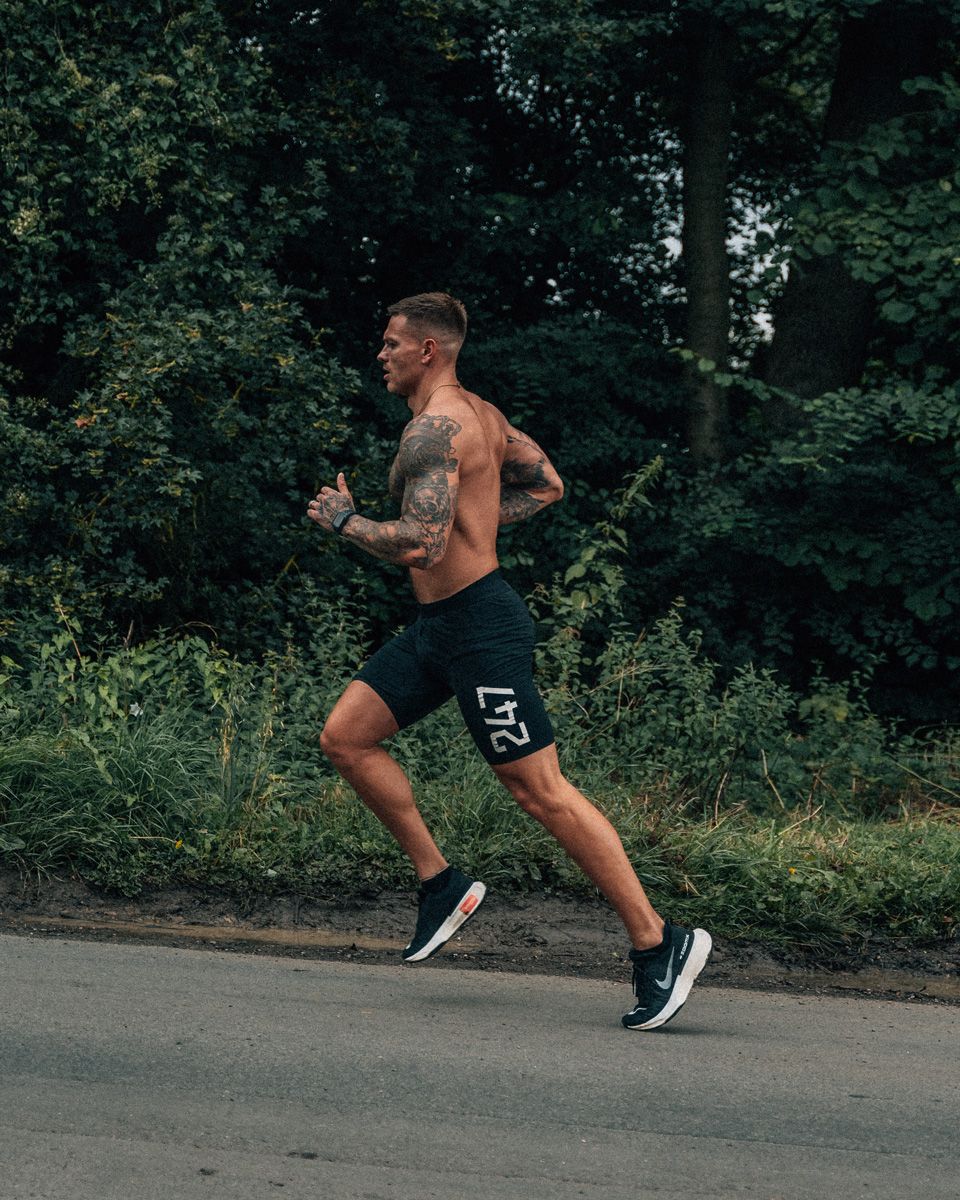 Coach is running outdoors.