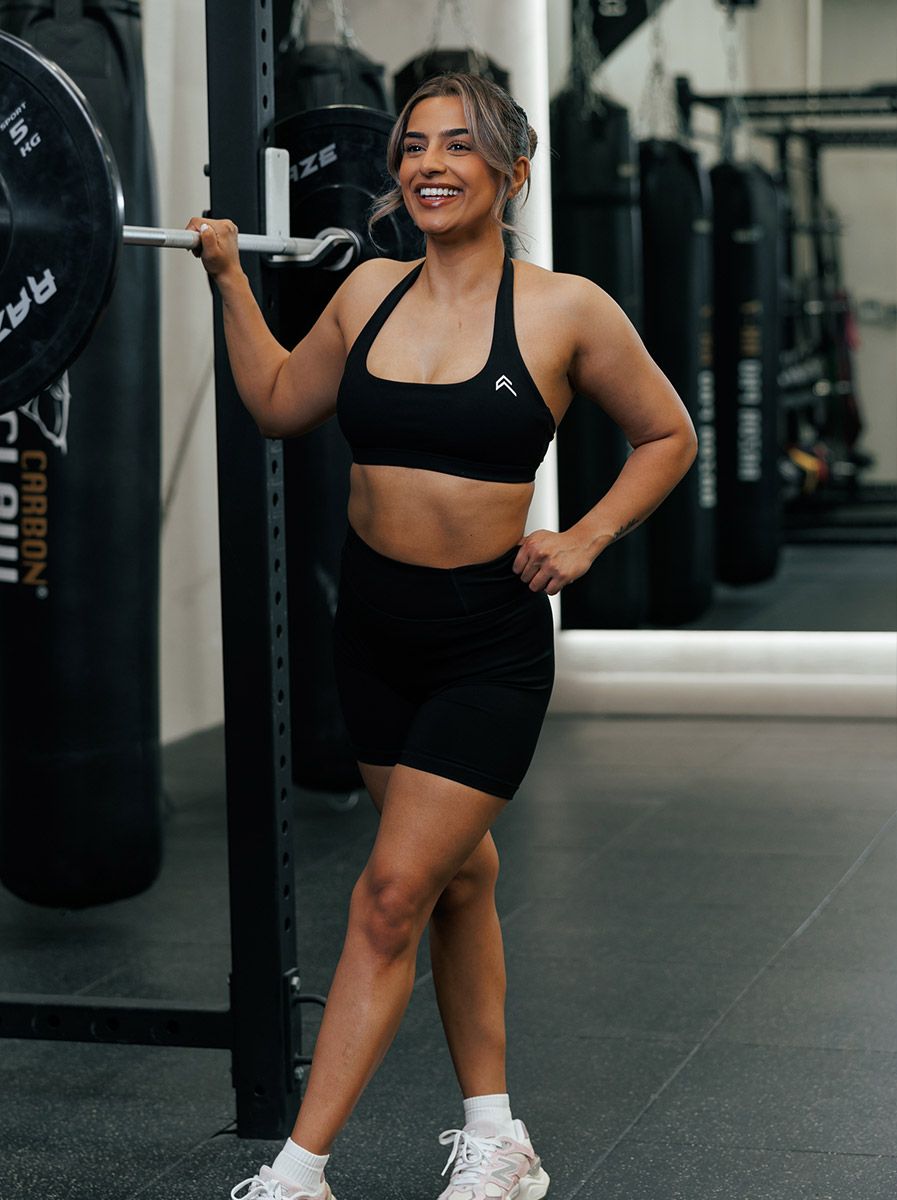 Coach is at the gym, smiling.