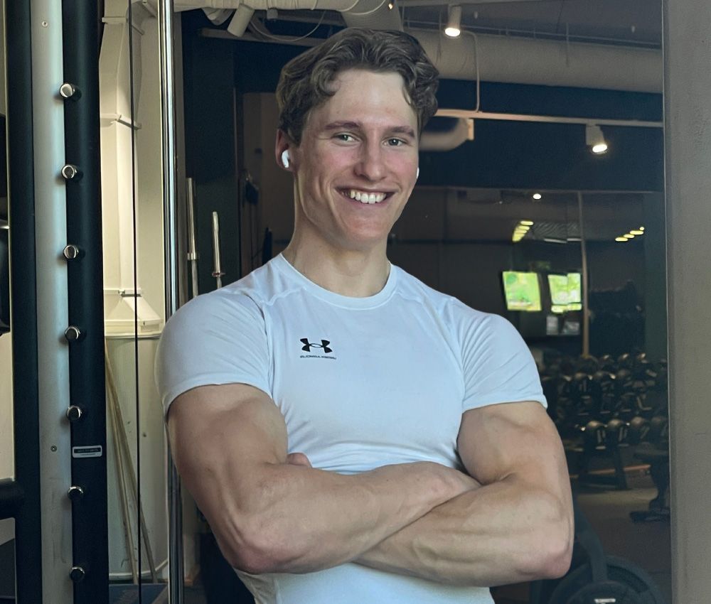 Man standing with his big muscles in gym