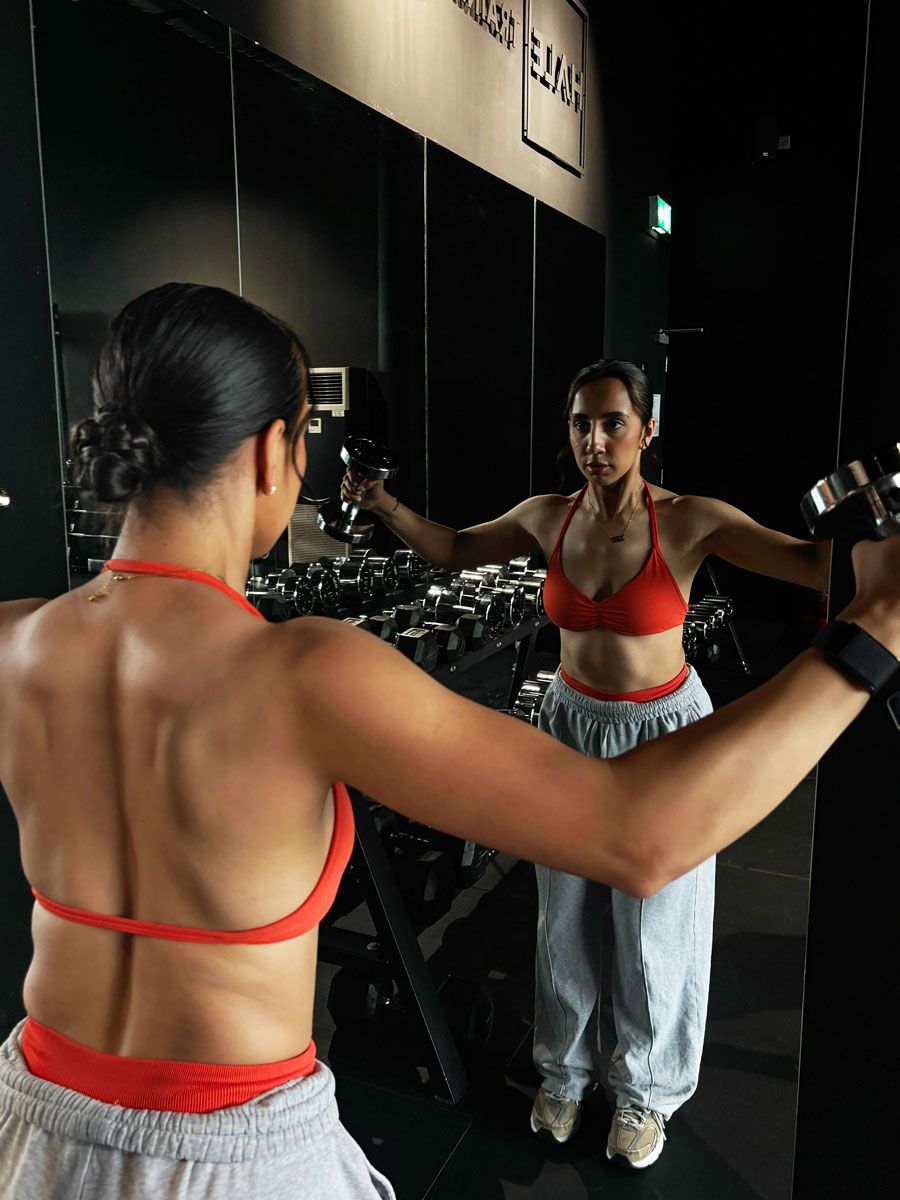 The coach is posing while looking at the mirror.